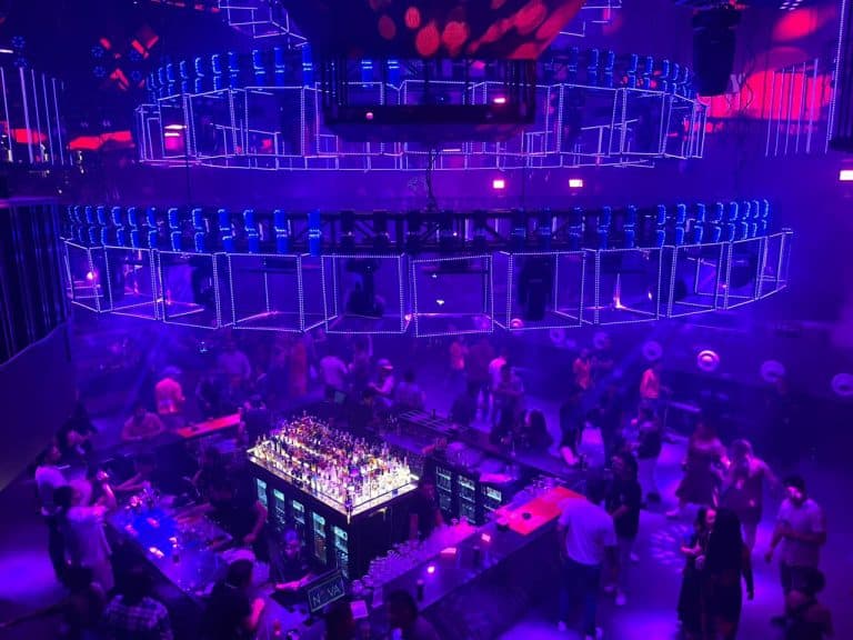 Club Nova main bar and private decks under purple lights